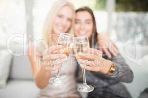 Beautiful women toasting champagne flute