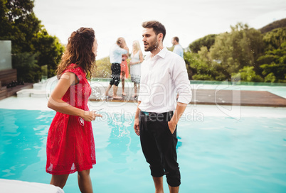 Friends talking near pool