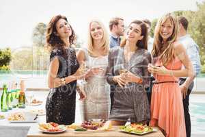 Happy young friends having drinks