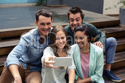 Happy friends taking selfie