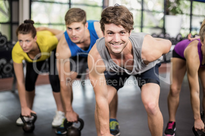 Fitness class lifting dumbbells