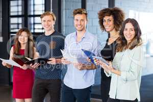 Colleagues standing with document and digital tablet