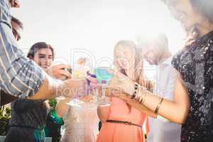 Happy young friends having drinks