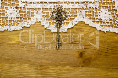 Vintage key on the white aged lace