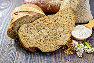 Bread buckwheat with cereals and flower on dark board