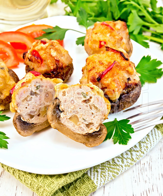 Champignons stuffed meat cut in white plate on napkin