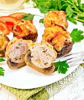 Champignons stuffed meat cut in white plate on napkin