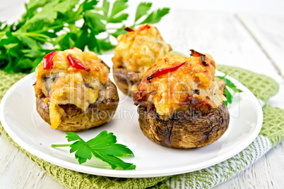 Champignons stuffed meat in white plate on board