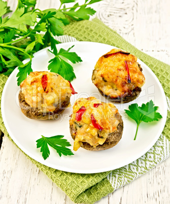 Champignons stuffed meat in white plate on napkin