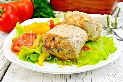 Cutlets of turkey with vegetables in plate on board