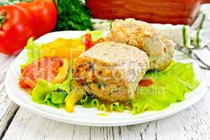 Cutlets of turkey with vegetables in plate on board