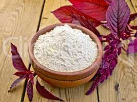 Flour amaranth in clay bowl on board with flower