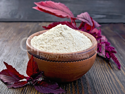 Flour amaranth in clay bowl on dark board