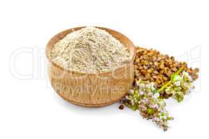 Flour buckwheat in bowl with cereals and flower