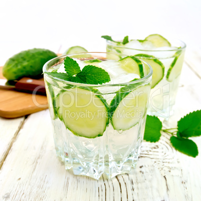 Lemonade with cucumber and mint in two glassful on board
