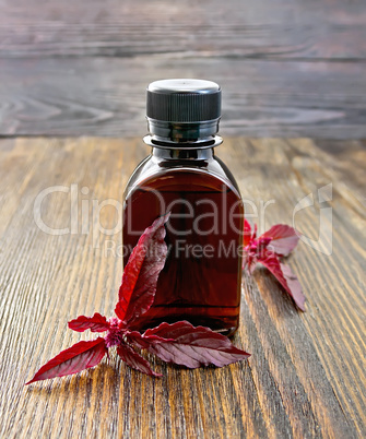 Oil with amaranth on dark board