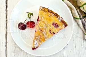 Pie cherry with sour cream in plate on board top