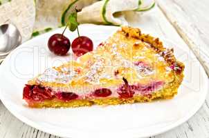 Pie cherry with sour cream in plate on board