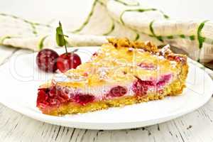 Pie cherry with sour cream in plate on light board