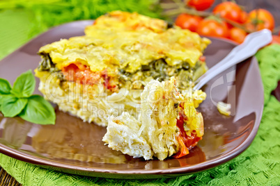 Pie potato with tomato and fork on board