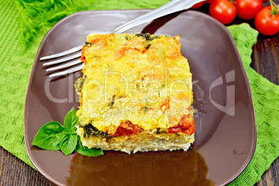 Pie potato with tomato on dark board