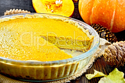 Pie pumpkin in pan on board