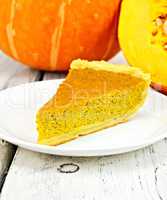 Pie pumpkin in plate on board