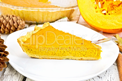 Pie pumpkin in plate on light board