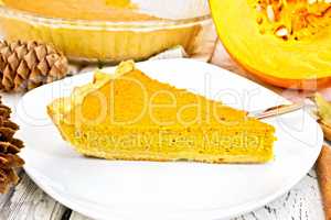 Pie pumpkin in plate on light board
