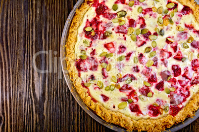 Pie strawberry-rhubarb in glass pan on board top