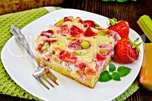 Pie strawberry-rhubarb with sour cream on dark board