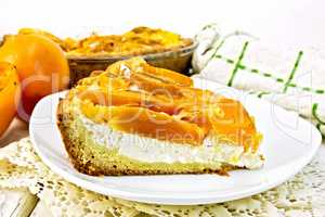 Pie with curd and persimmons in plate on napkin