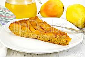 Pie with pears and honey in plate on board
