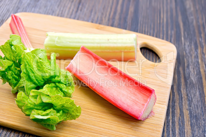 Rhubarb with leaf on dark board