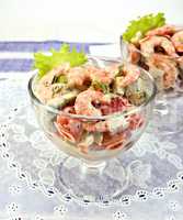 Salad with shrimp and tomatoes in glass on white napkin