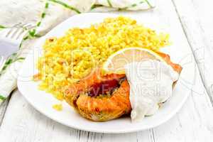 Salmon with lemon and rice on board