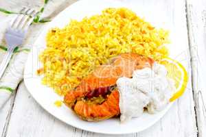Salmon with lemon and rice on light board