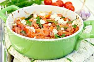 Shrimp and tomatoes with feta in pan on napkin