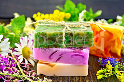 Soap homemade with flowers and leaves on board