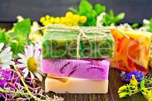 Soap homemade with flowers and leaves on board