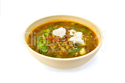 Soup lentil with spinach and cheese in yellow bowl
