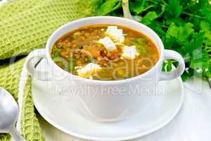 Soup lentil with spinach and cheese on board