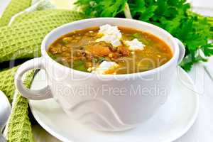 Soup lentil with spinach and feta on board