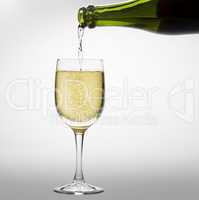 Pouring sparkling white wine into a wineglass
