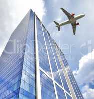 A jet plane flying low over Office building