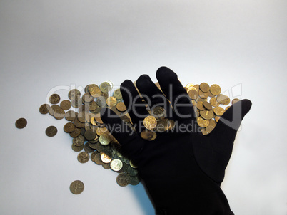 gloved hand holds coins, over a bunch of triffle