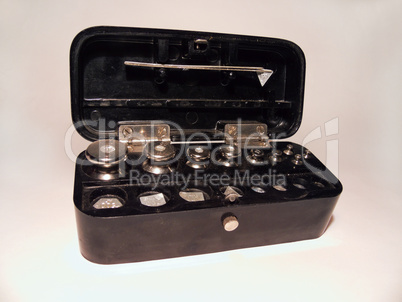 set of laboratory weights steel tweezers, folded in a box