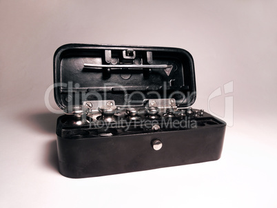 set of laboratory weights steel tweezers, folded in a box