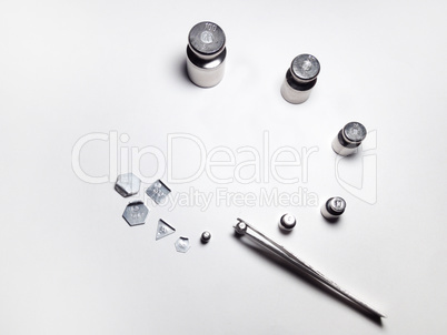 set of laboratory weights and steel tweezers