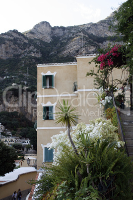 beautiful building on a background of mountains. Surrounded by flowers